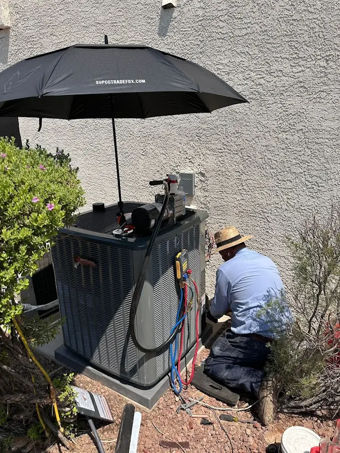 HVAC technician performing outdoor AC maintenance in Dunkirk